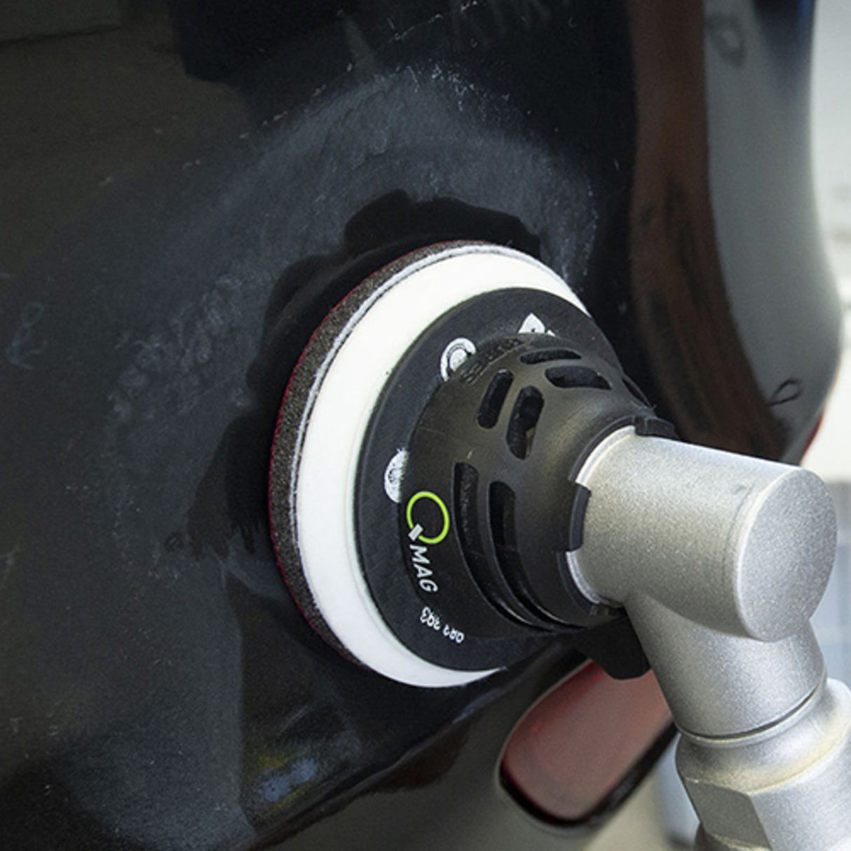 sanding tool on a car surface