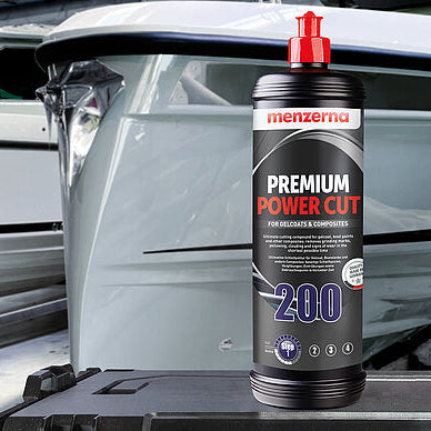 Menzerna Premium Power Cut 200 car polish bottle with a boat in the background