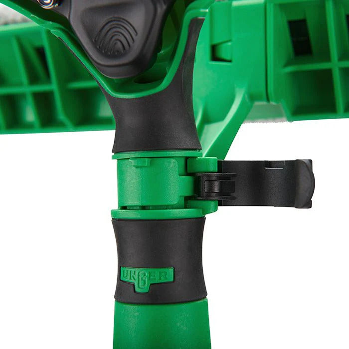 Close-up of a green and black Unger tool on a white background