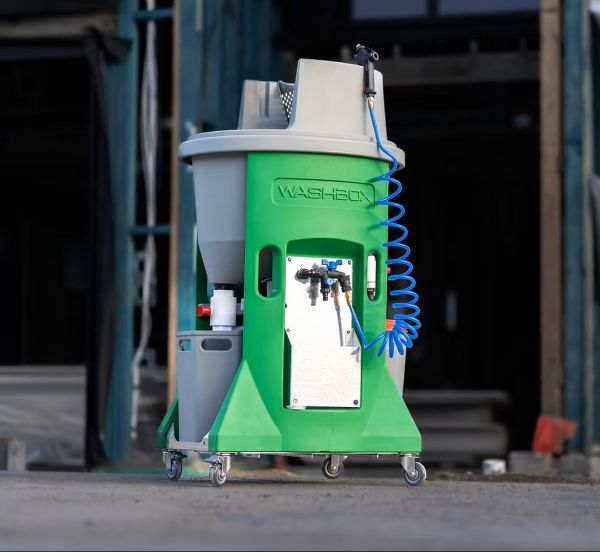 Washbox rocket cleaning machine with a coiled hose on a concrete floor.