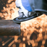 Person wearing blue gloves using a grinder on a metal pipe with sparks flying.