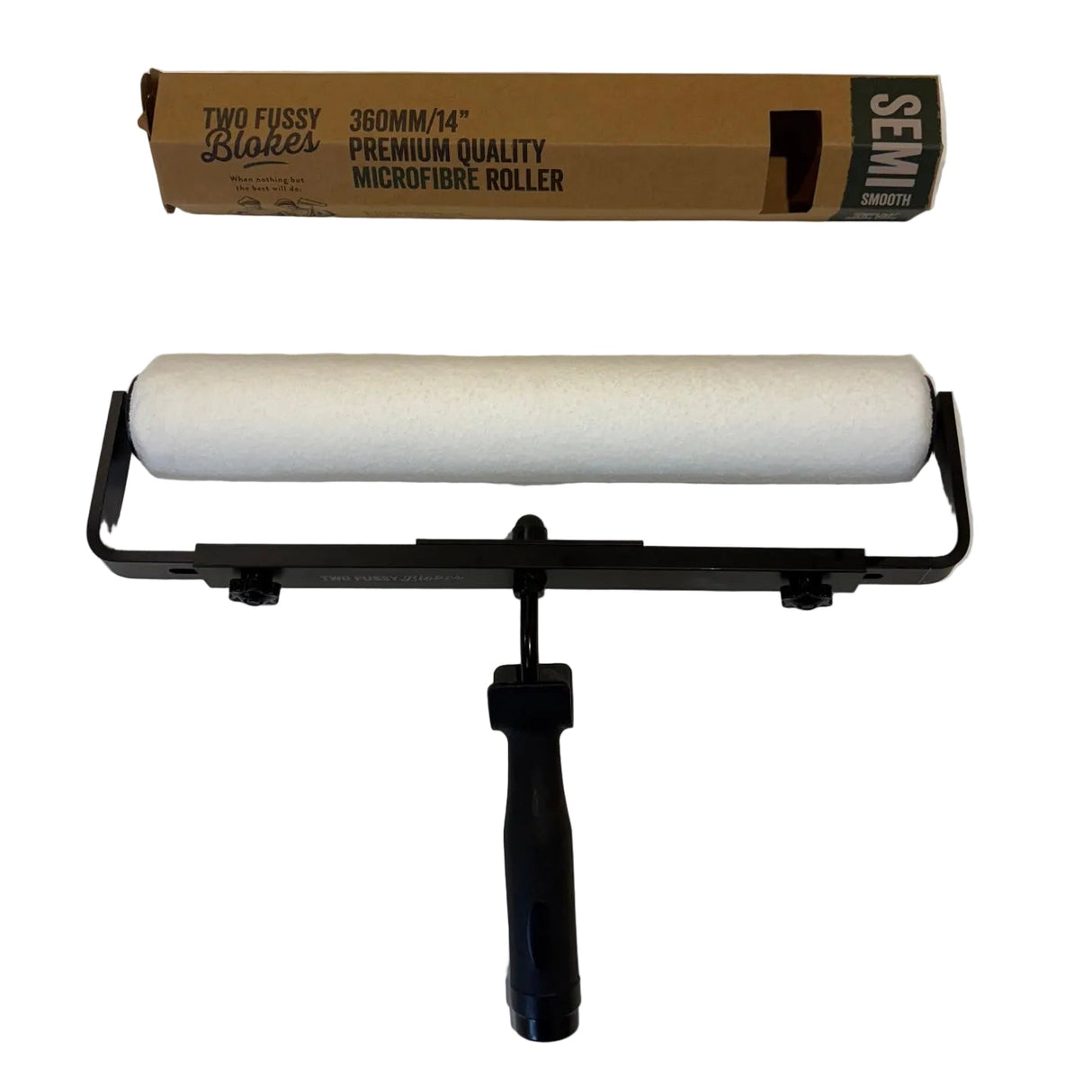 Roller with black handle and white roller sleeve on a white surface, with packaging in the background.