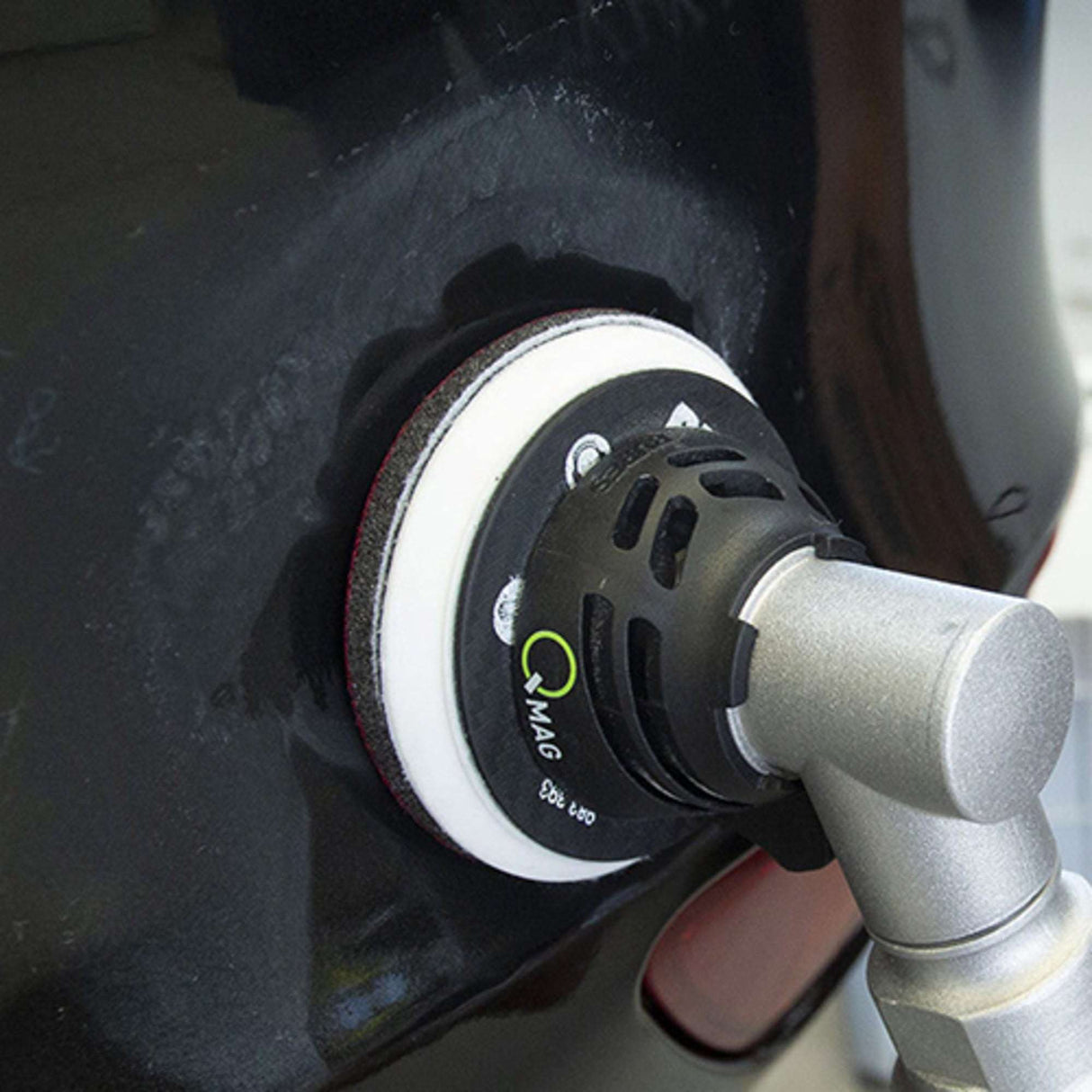 sanding tool on a car surface 