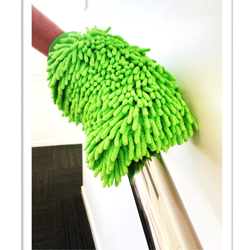 Green microfiber dust mop against a white background