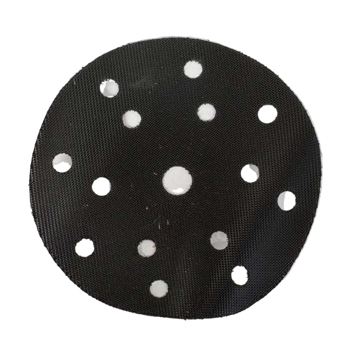 A round black sanding disc with multiple circular holes, photographed flat on top of a white sheet of paper.