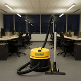 Yellow and black vacuum cleaner with attachments on a white background