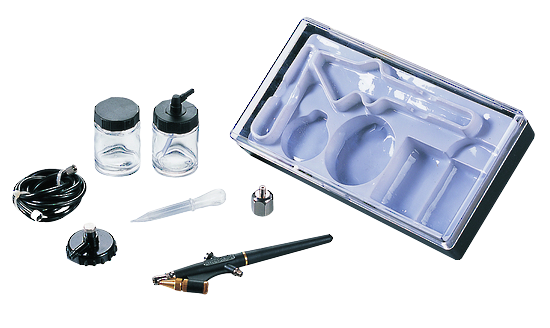 An airbrush kit with a black and gold airbrush pen, two small glass bottles with black caps, a black hose, a small plastic pipette, a metal cap, and a clear plastic storage tray on a white background.