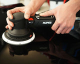 Person using a Rupes sander on a car surface