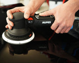 Person using a Rupes sander on a car surface