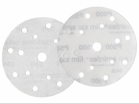 Two sanding discs with multiple holes on a white background