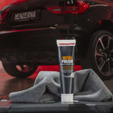Menzerna metal polish tube with a car in the background