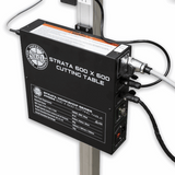 A black Strata 600 x 600 cutting table motor enclosure mounted on a silver vertical column with visible cables and connectors against a white background.